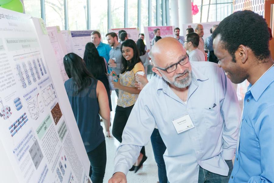 people looking at a poster