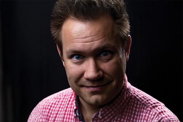 Smiling man posing for a headshot photo