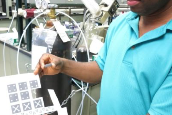 Dr. Badu-Tawiah displaying the test he created