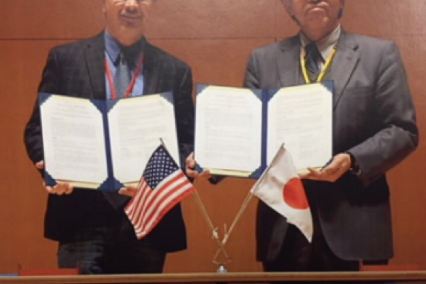 Representatives from OSU and Kyoto University hold up the Memorandum of Understanding