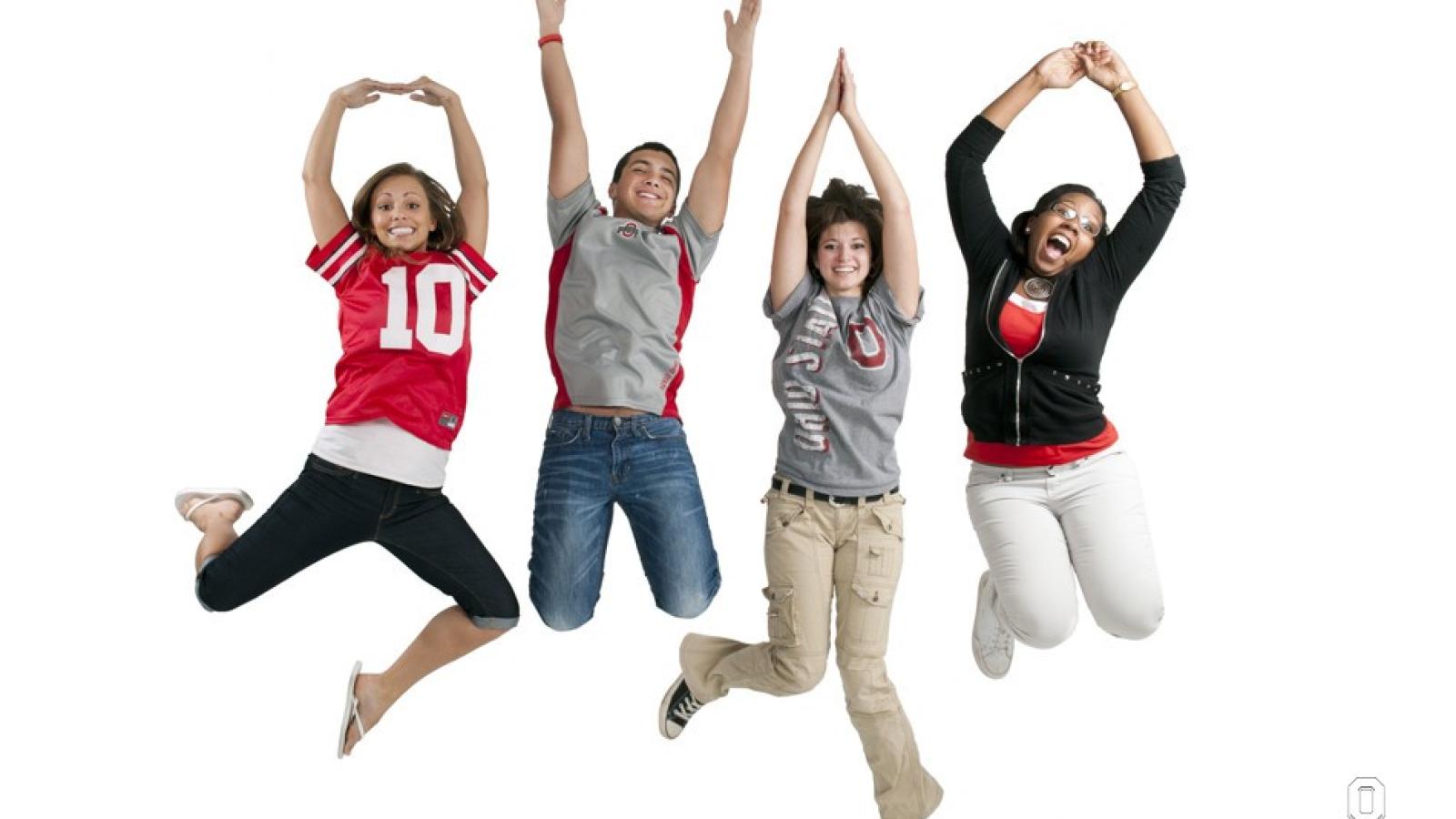 Students jumping in the air and displaying O-H-I-O with their arms